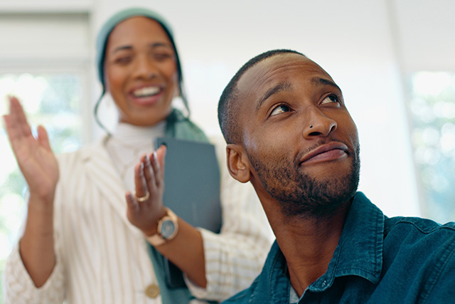 Man in office with proud team [Adobe Stock - Jordi P DE/peopleimages.com]